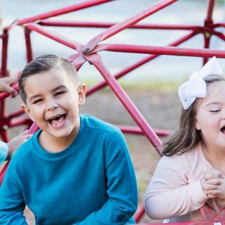 A group of children with a disability playing together in the park