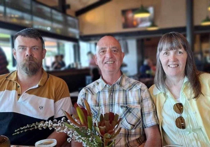 Aruma participant Kale with his Volunteer host family Ben and Jean Lou Tomasiello dining out at a restaurant together.